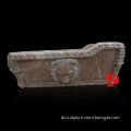 brown antique stone bathtub with lion head decoration